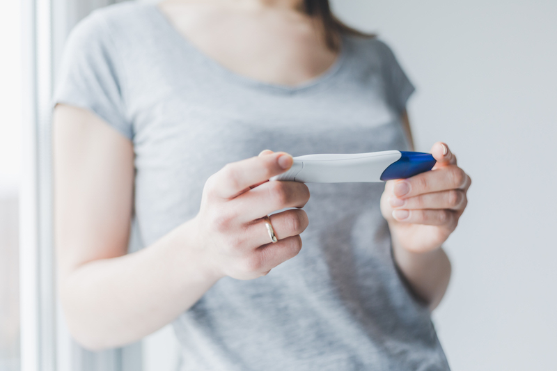 woman-looking-and-checking-pregnancy-test-2021-08-26-18-55-18-utc